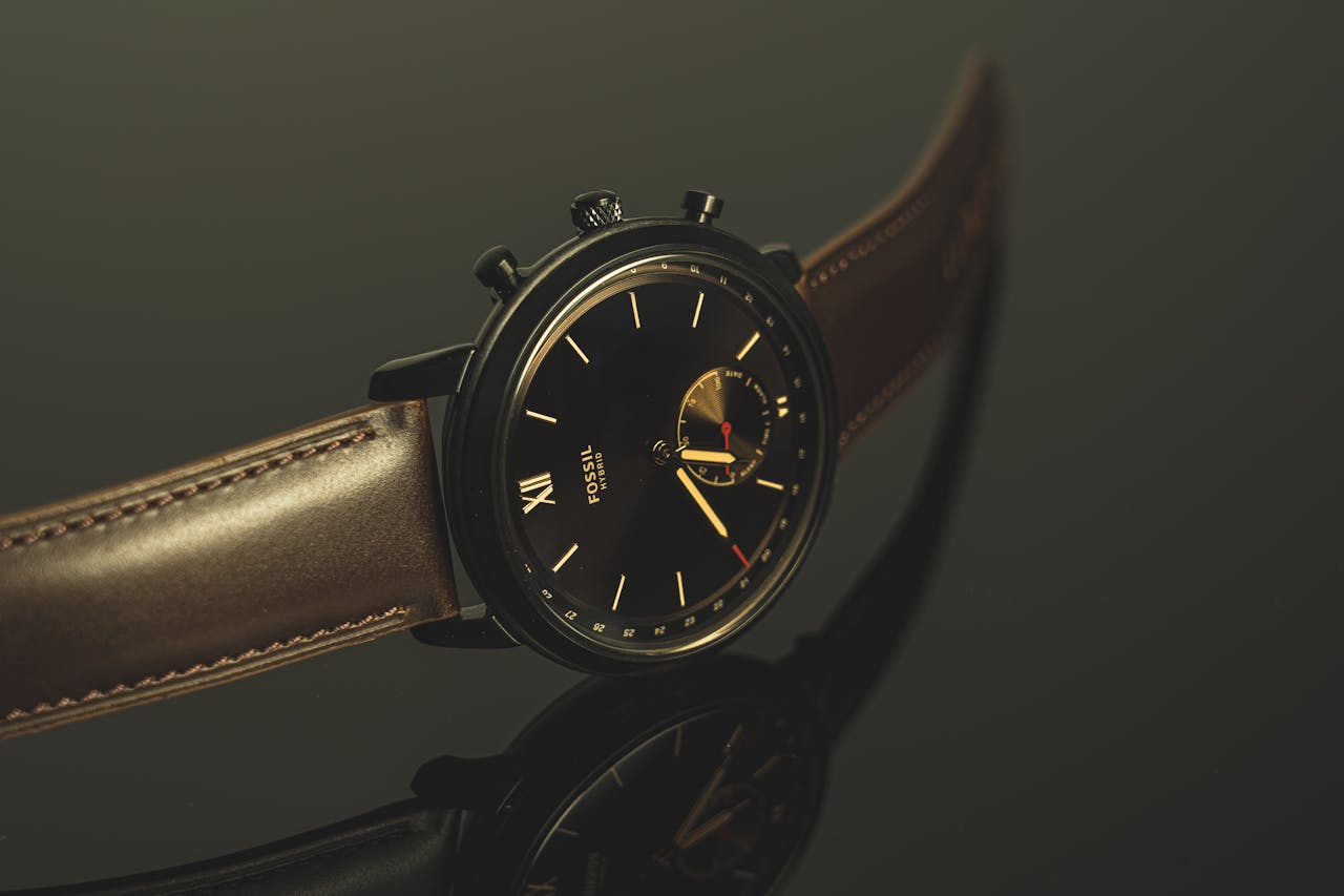hero-img-01 Luxurious black wristwatch with leather strap and analog display in close-up view.
